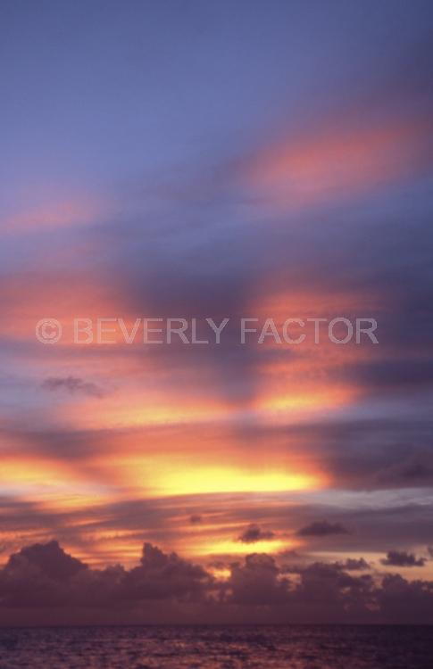 Islands;sunsets;sky;clouds;colorful;blue water;sun;yellow;red;pink;sillouettes;blue;palau micronesia